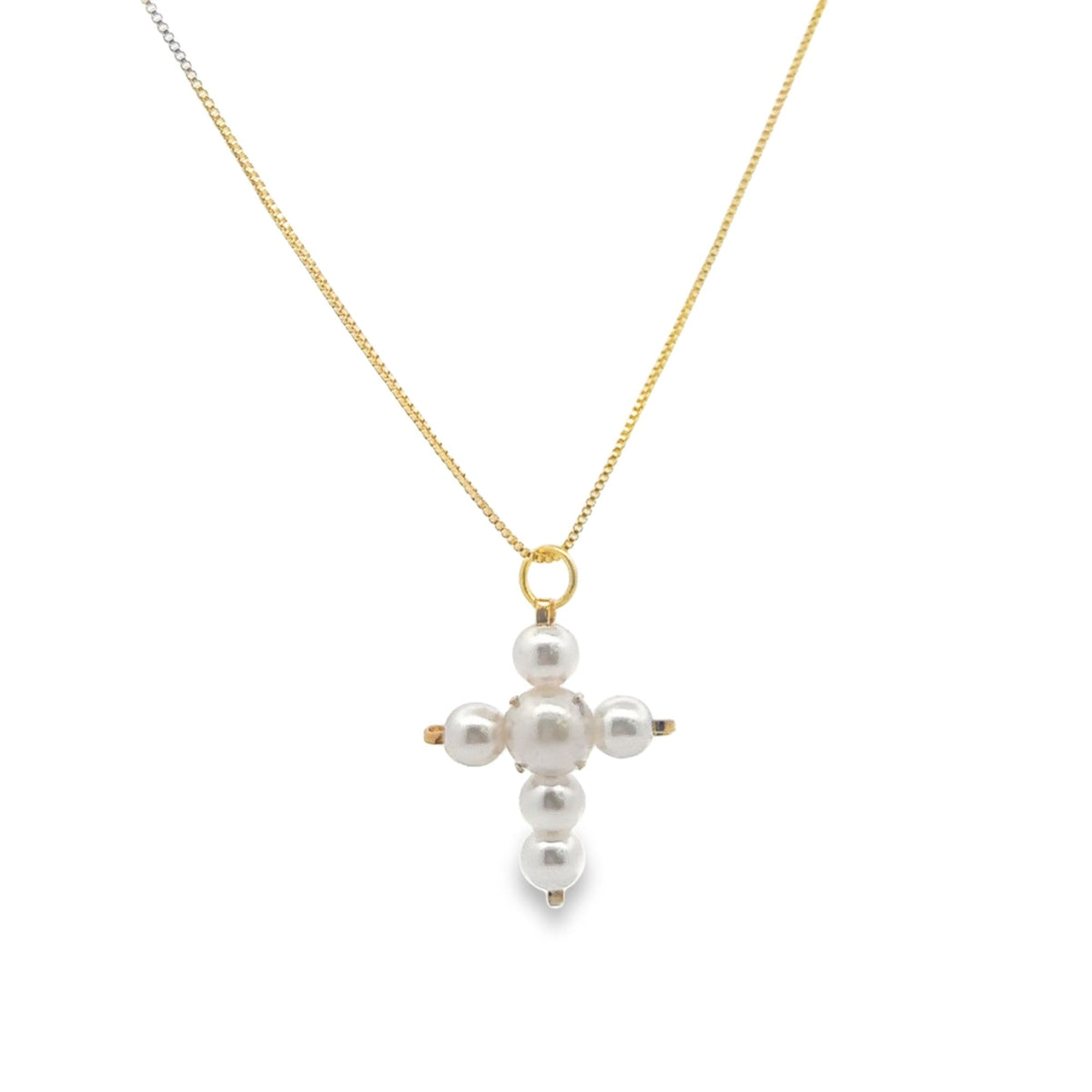 A delicate gold chain holds a pearl cross pendant featuring lustrous round pearls arranged in a cruciform shape against a clean white background.
