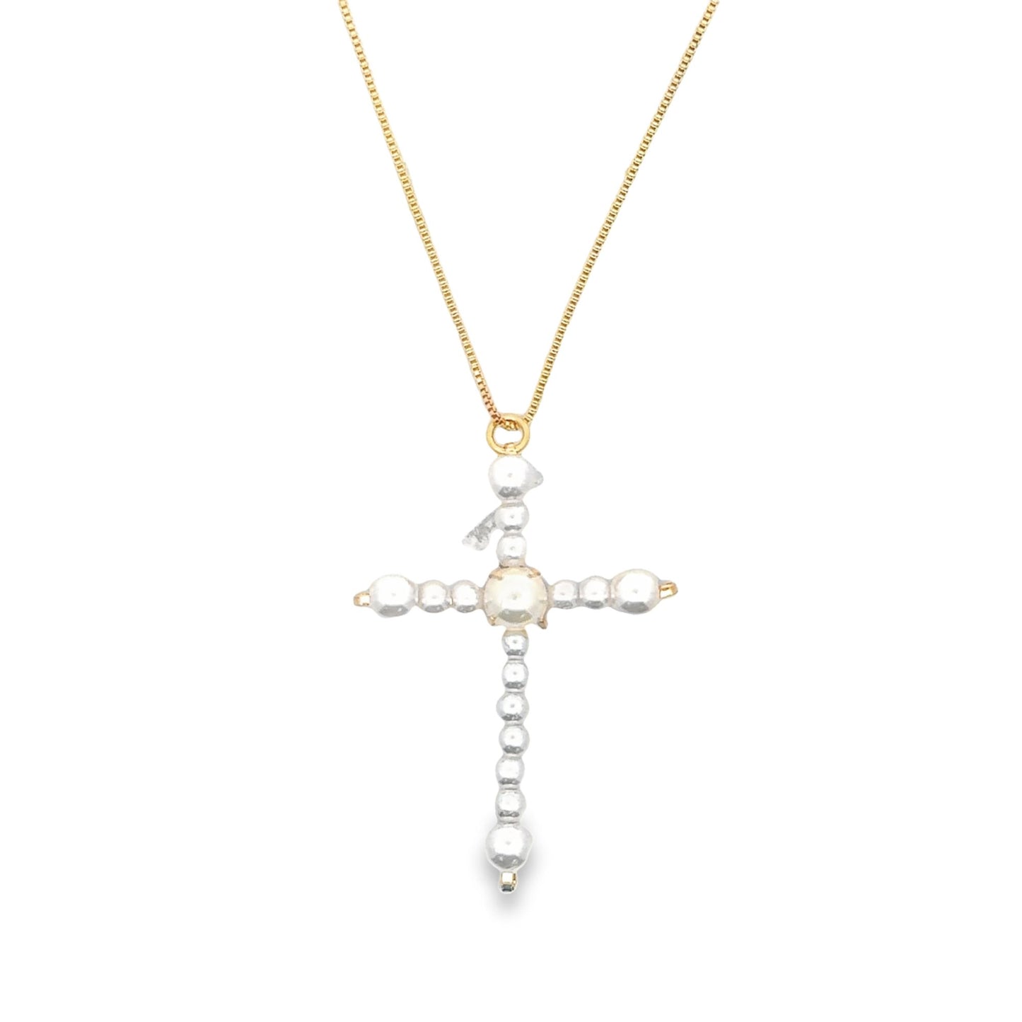 A delicate gold chain holds a unique cross pendant crafted from irregularly shaped white pearls against a plain white background.