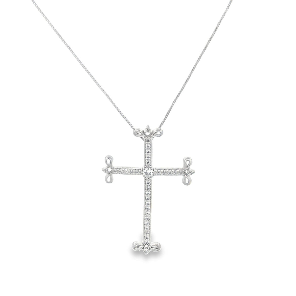 A delicate silver cross pendant embellished with sparkling diamonds hangs gracefully from a matching thin chain necklace.