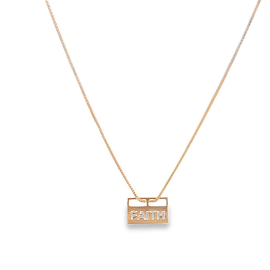 A delicate gold necklace displays a rectangular pendant engraved with the word FAITH.