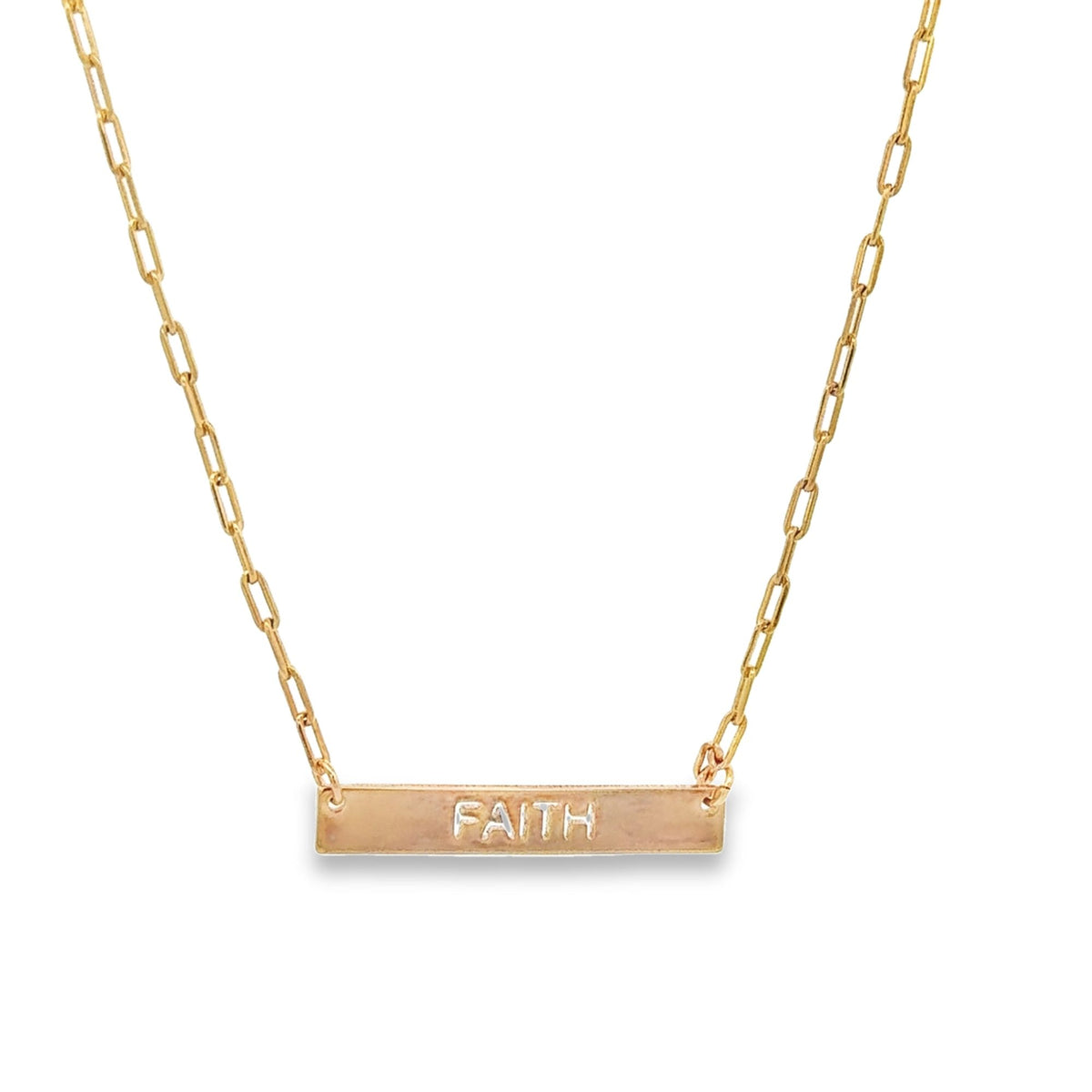 A delicate gold chain holds a bar pendant featuring the engraved word "FAITH".