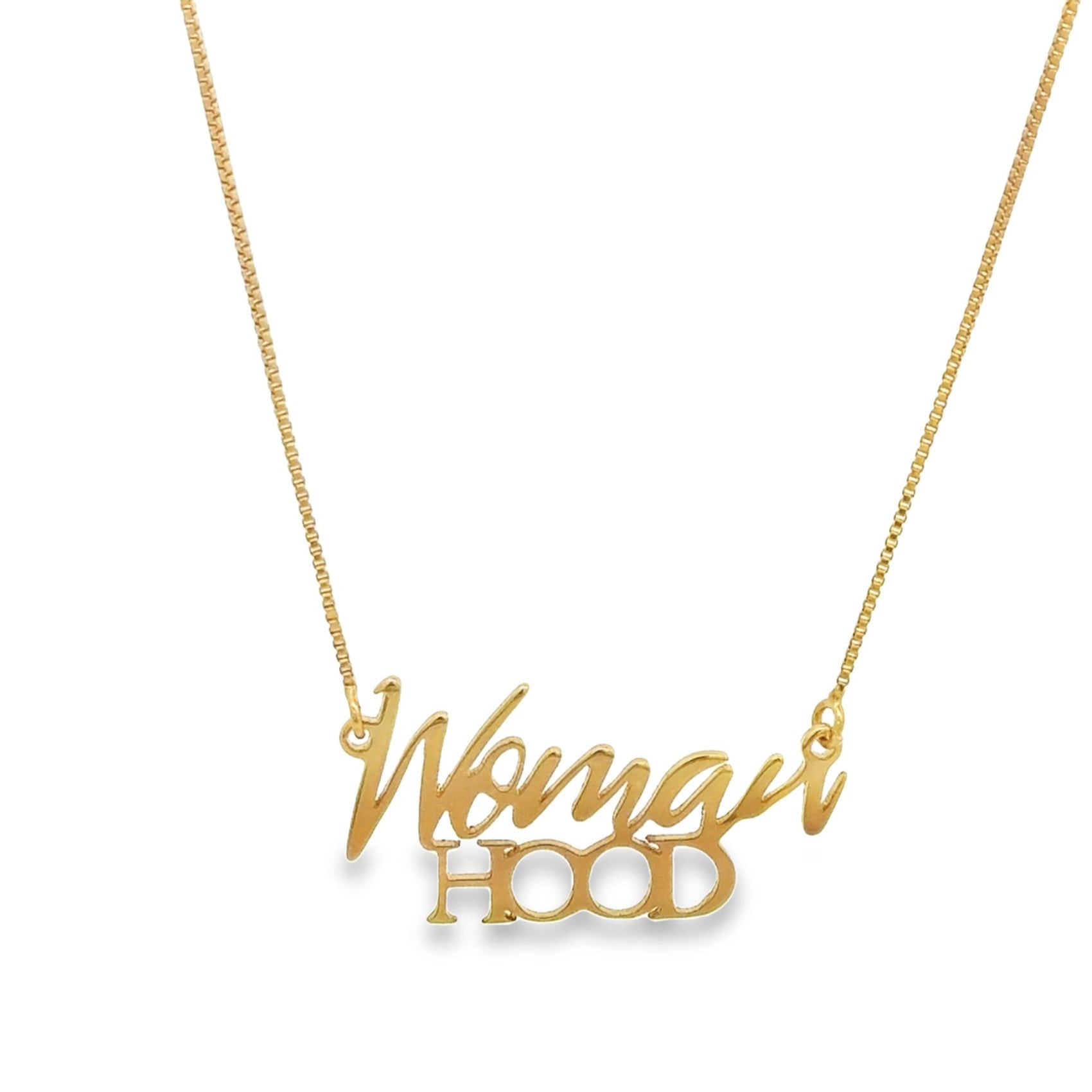 A delicate gold chain necklace displays the word "Womanhood" in a cursive script pendant.