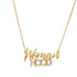 A delicate gold chain necklace displays the word "Womanhood" in a cursive script pendant.