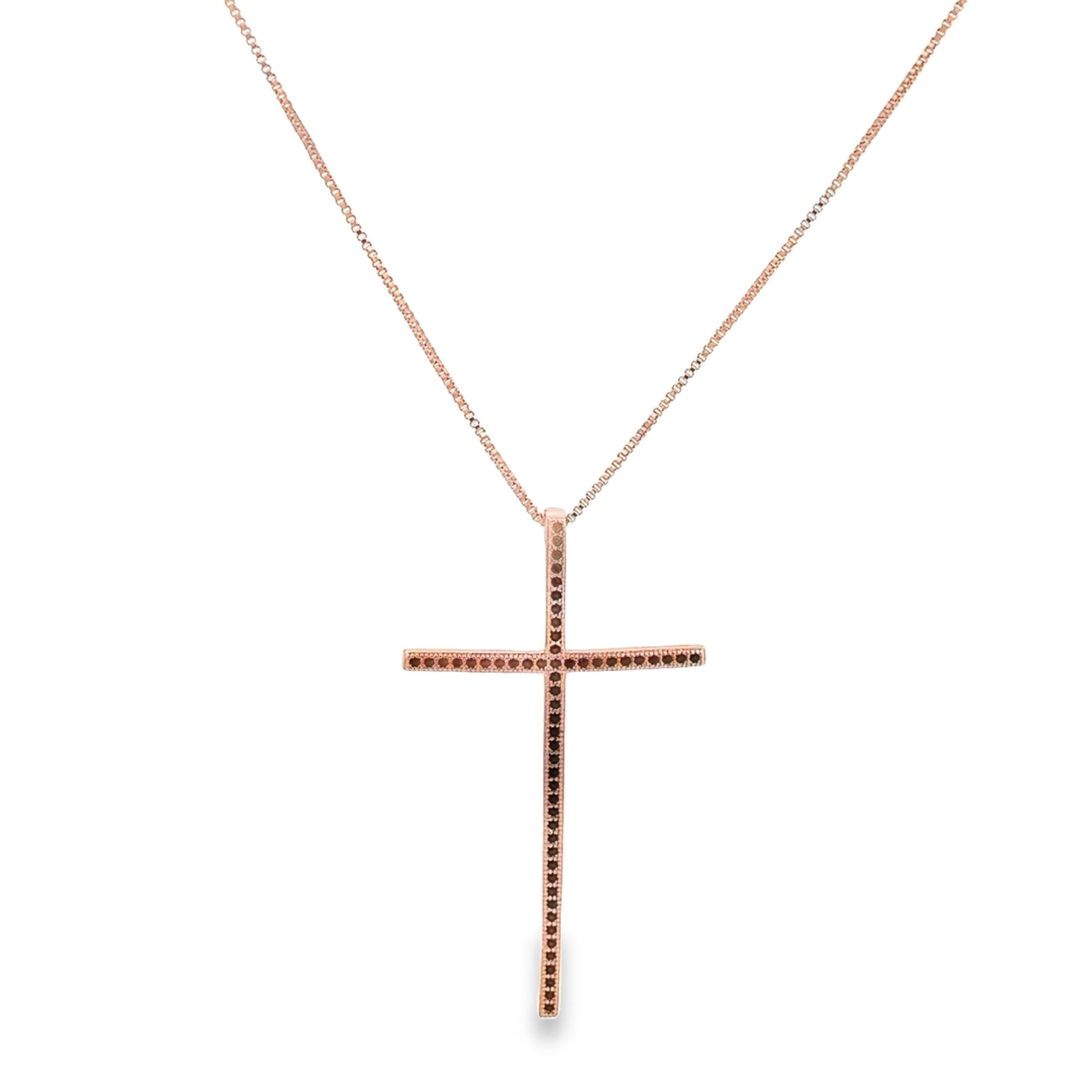 A rose gold cross pendant necklace featuring inlaid black diamonds hangs against a plain white background.