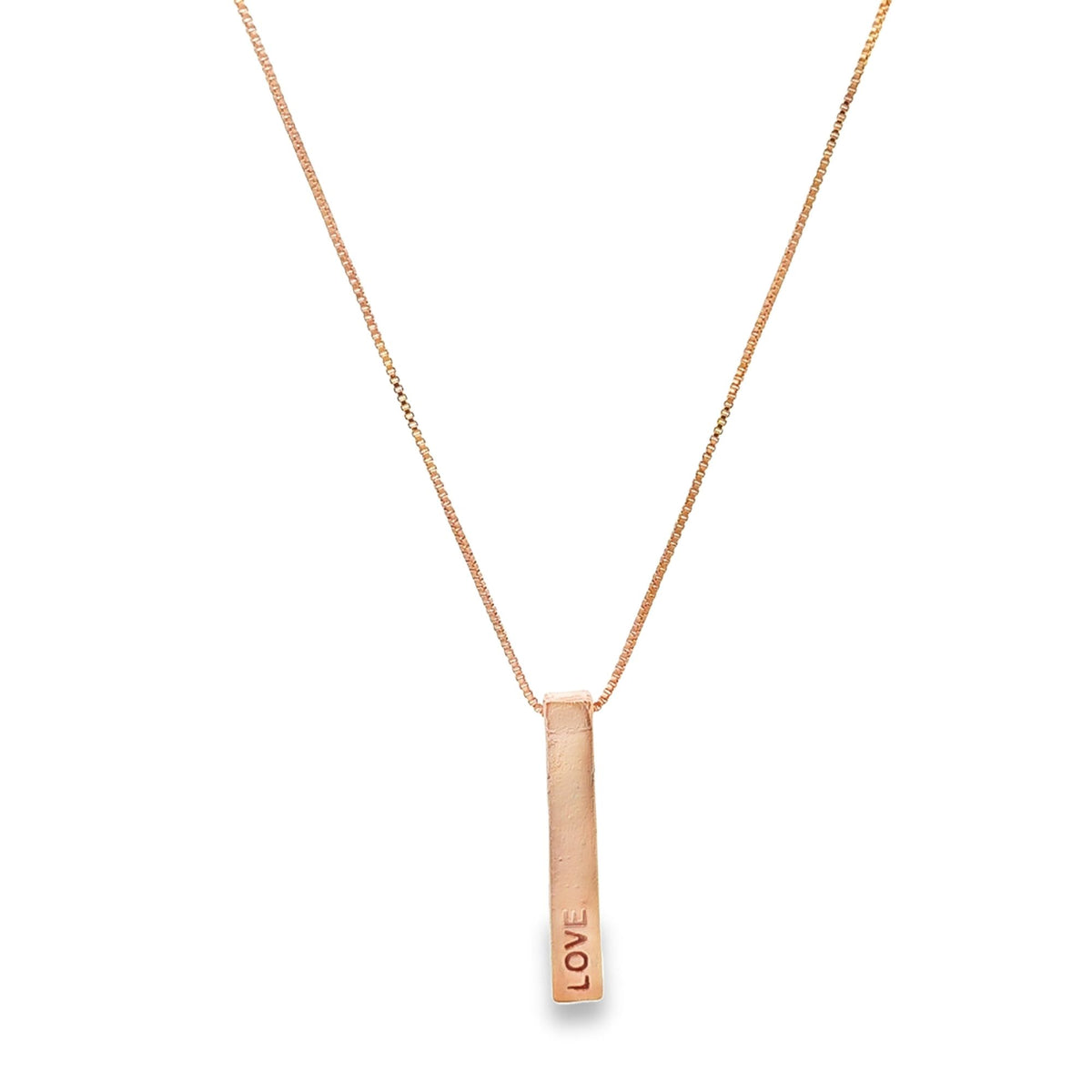 A delicate rose gold box chain necklace features a vertical bar pendant stamped with the word LOVE.