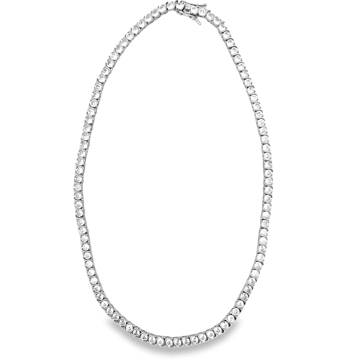 A sparkling diamond tennis necklace rests in an oval loop on a clean white background.