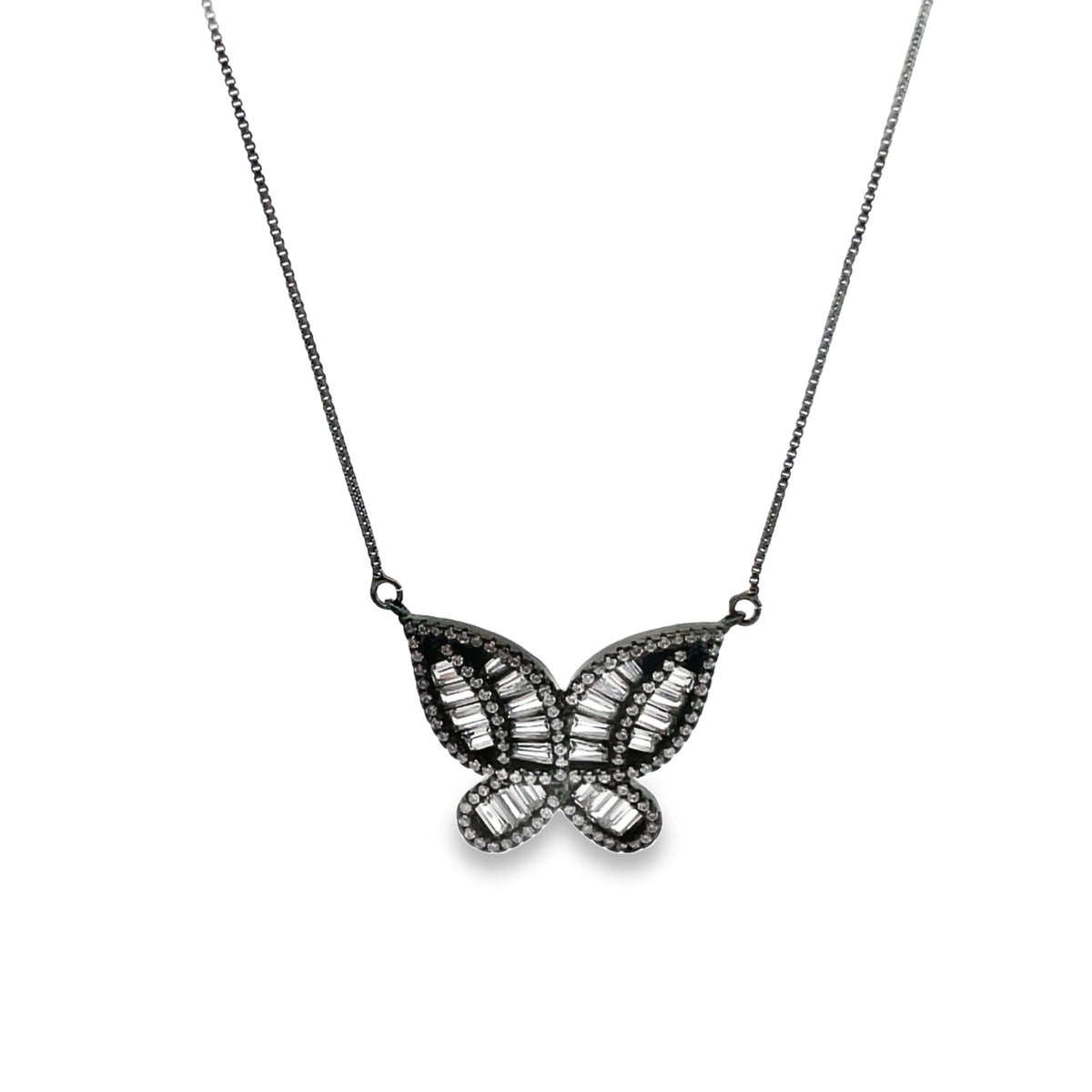 A delicate silver butterfly necklace sparkles with baguette-cut diamonds on a fine chain against a plain background.
