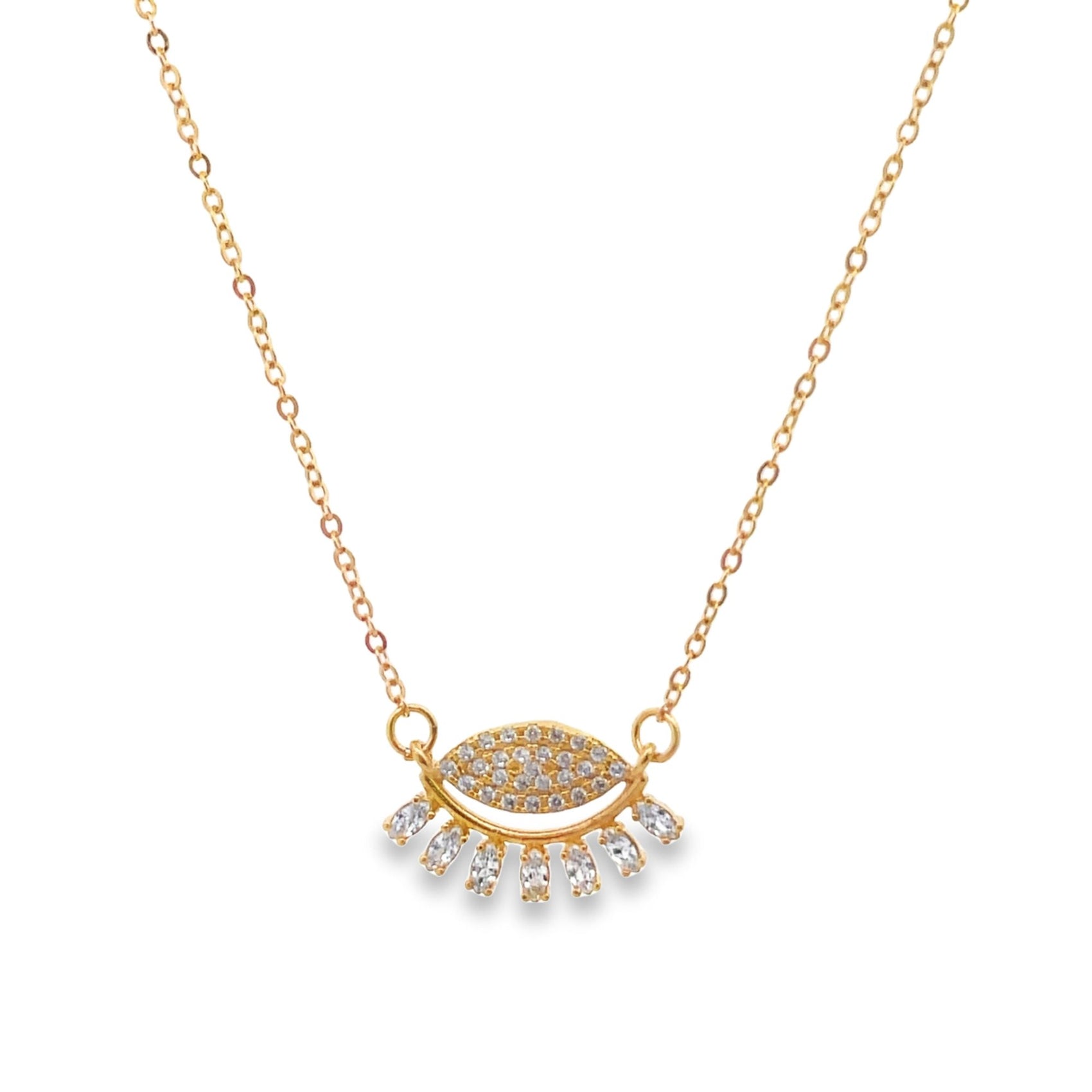 A delicate gold evil eye necklace features sparkling cubic zirconia crystals on a fine chain against a white background.