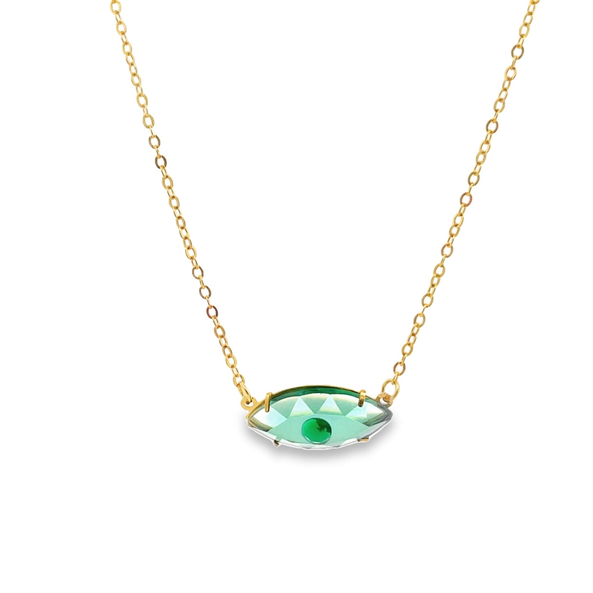 A delicate gold chain holds a sparkling green crystal eye pendant against a white background.