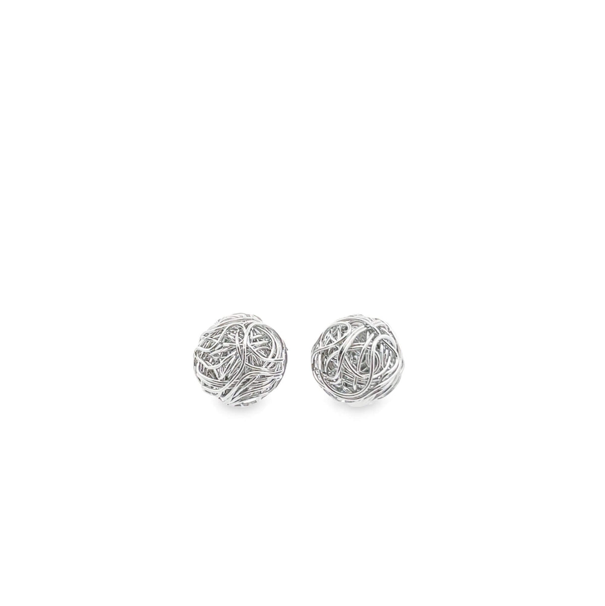 A pair of silver wire-wrapped ball stud earrings rests against a clean white background.