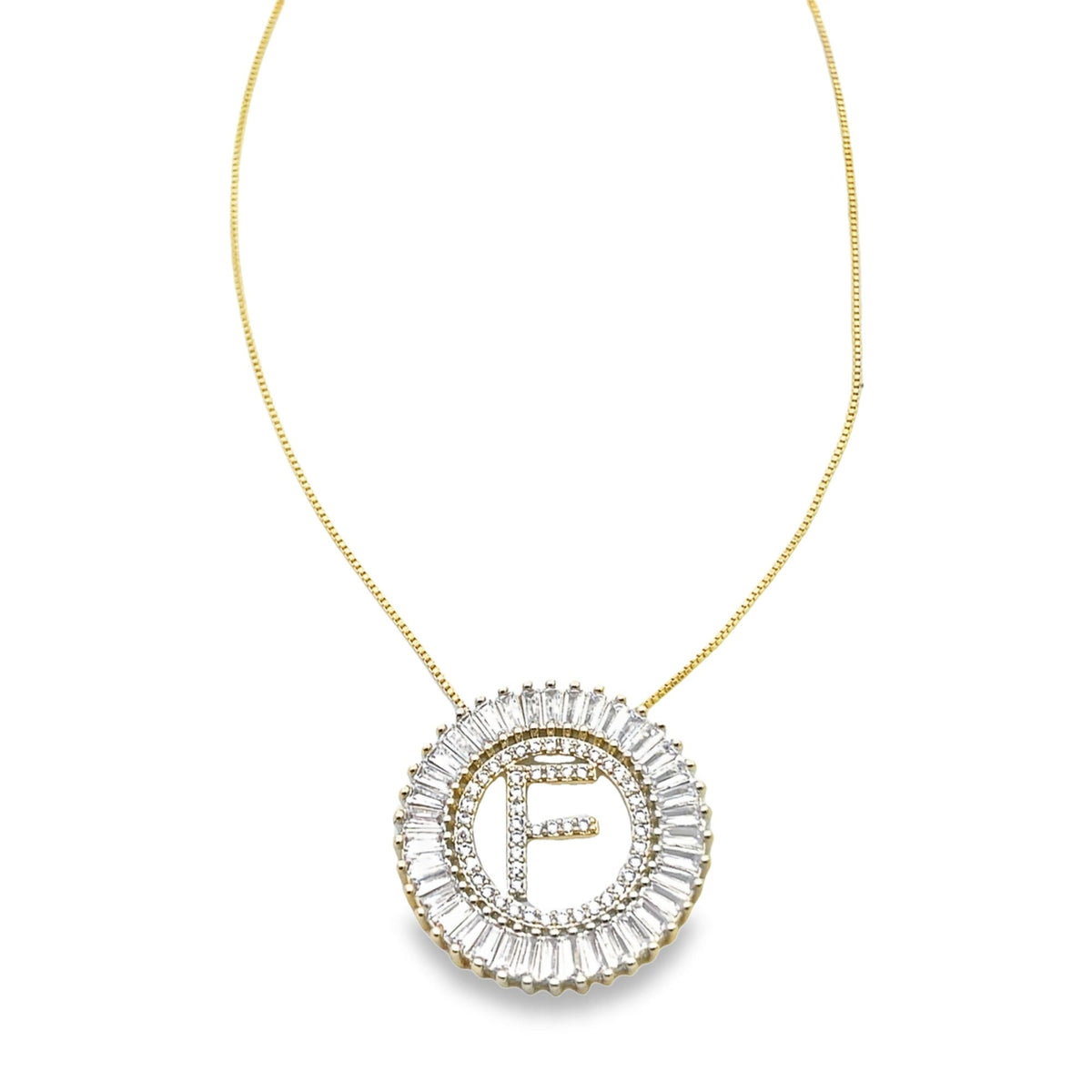 A delicate gold chain holds a sparkling initial F pendant encased within a circular halo of baguette and round cut diamonds.