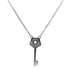 A delicate silver chain necklace features a sparkling key pendant adorned with pave crystals and a central star cutout.