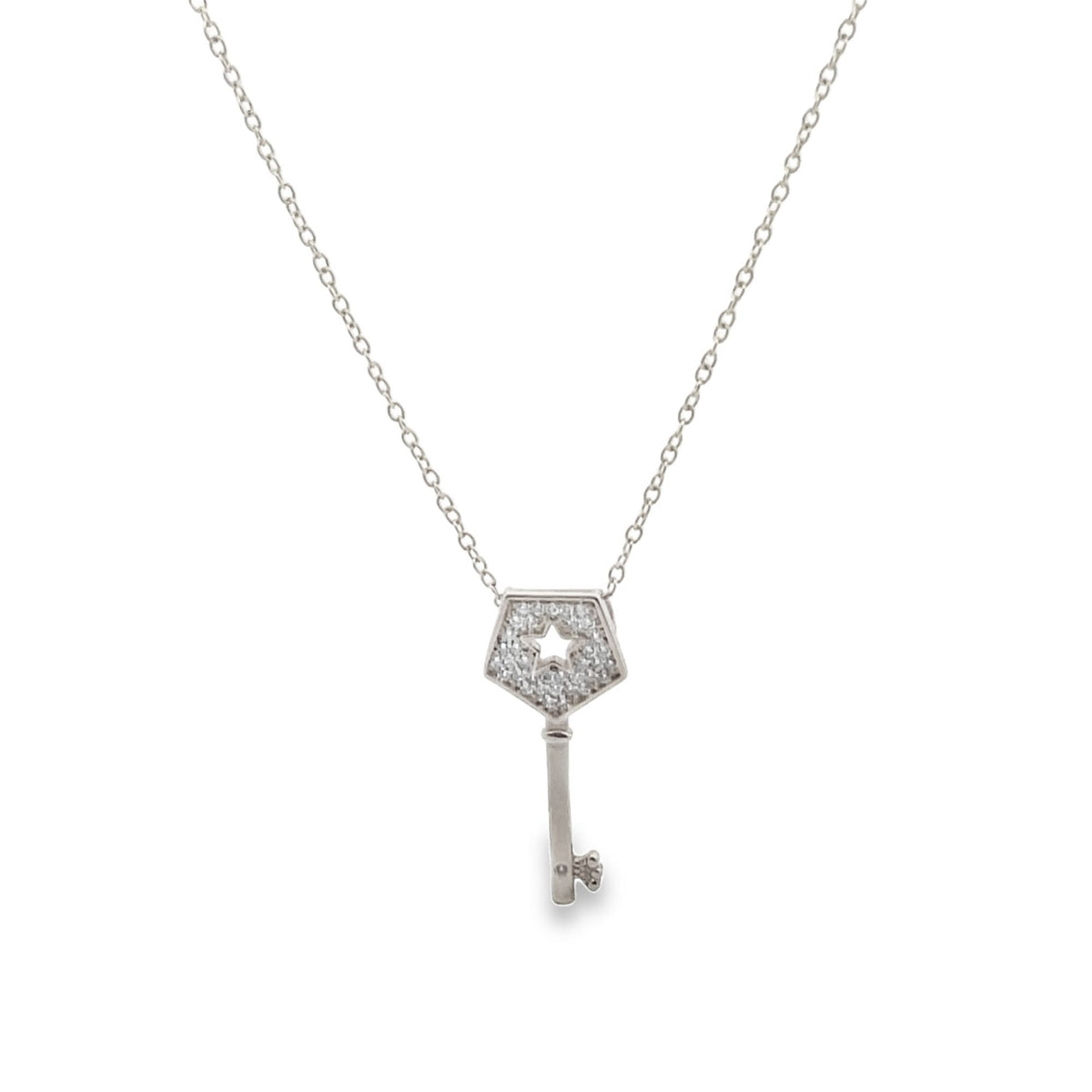 A delicate silver chain necklace features a pavé-set diamond key pendant with a star-shaped cutout.