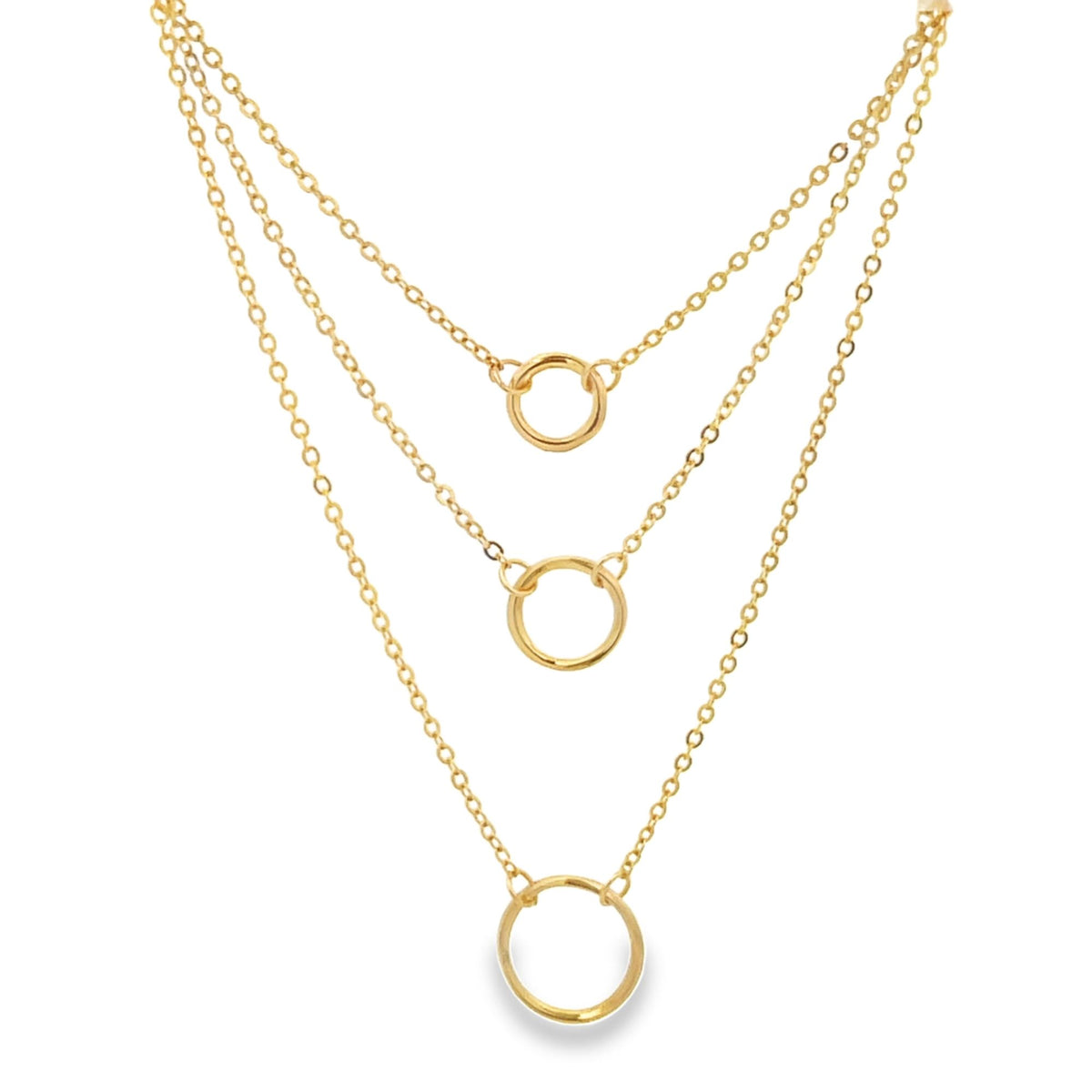 A delicate multi-strand gold layered necklace features three dainty circular pendants descending against a white background.
