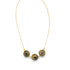 A delicate gold chain necklace dangles gracefully, showcasing three circular pendants encrusted with dark, sparkling gemstones against a clean white background.