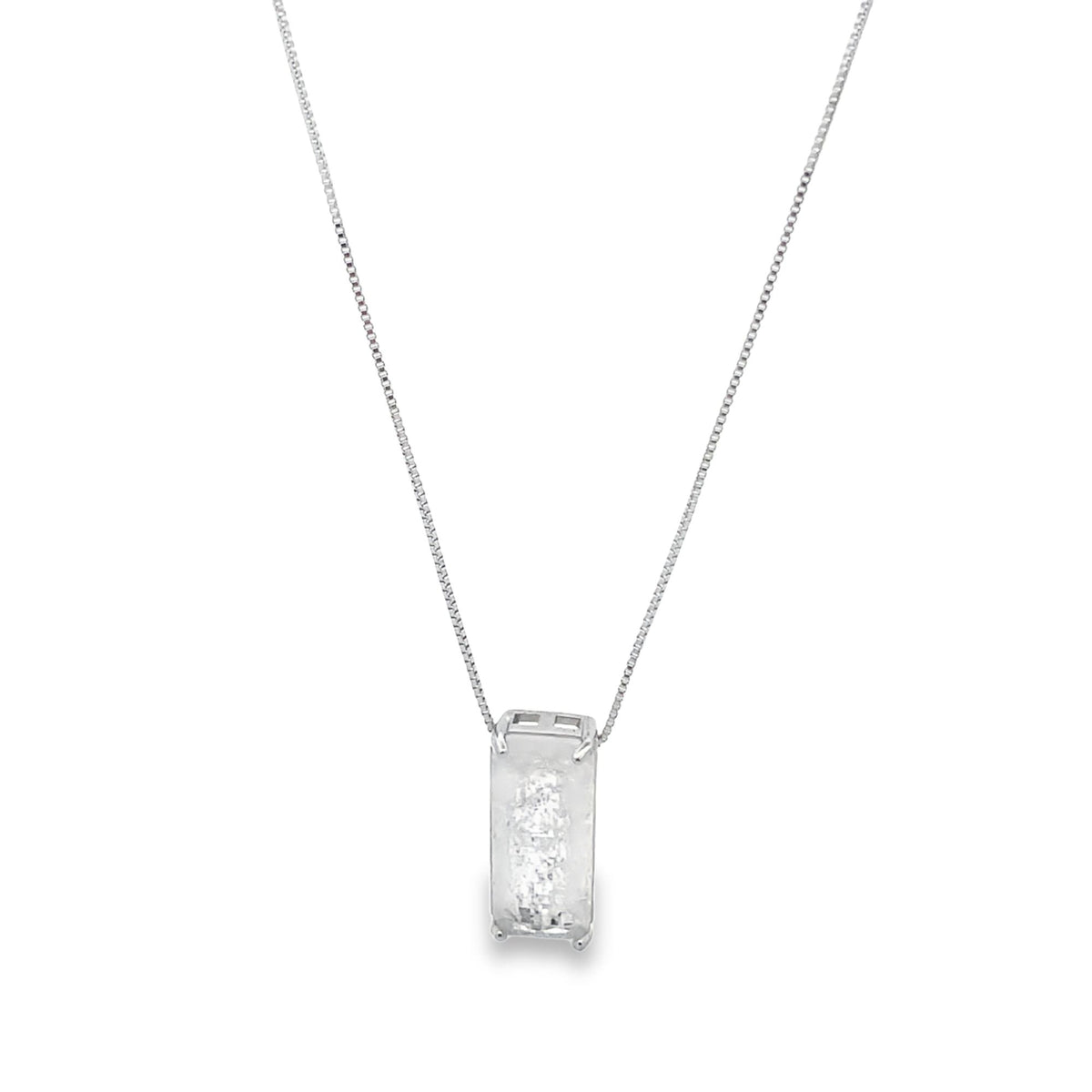 A delicate silver box chain necklace features an emerald-cut diamond pendant centered against a clean white background.