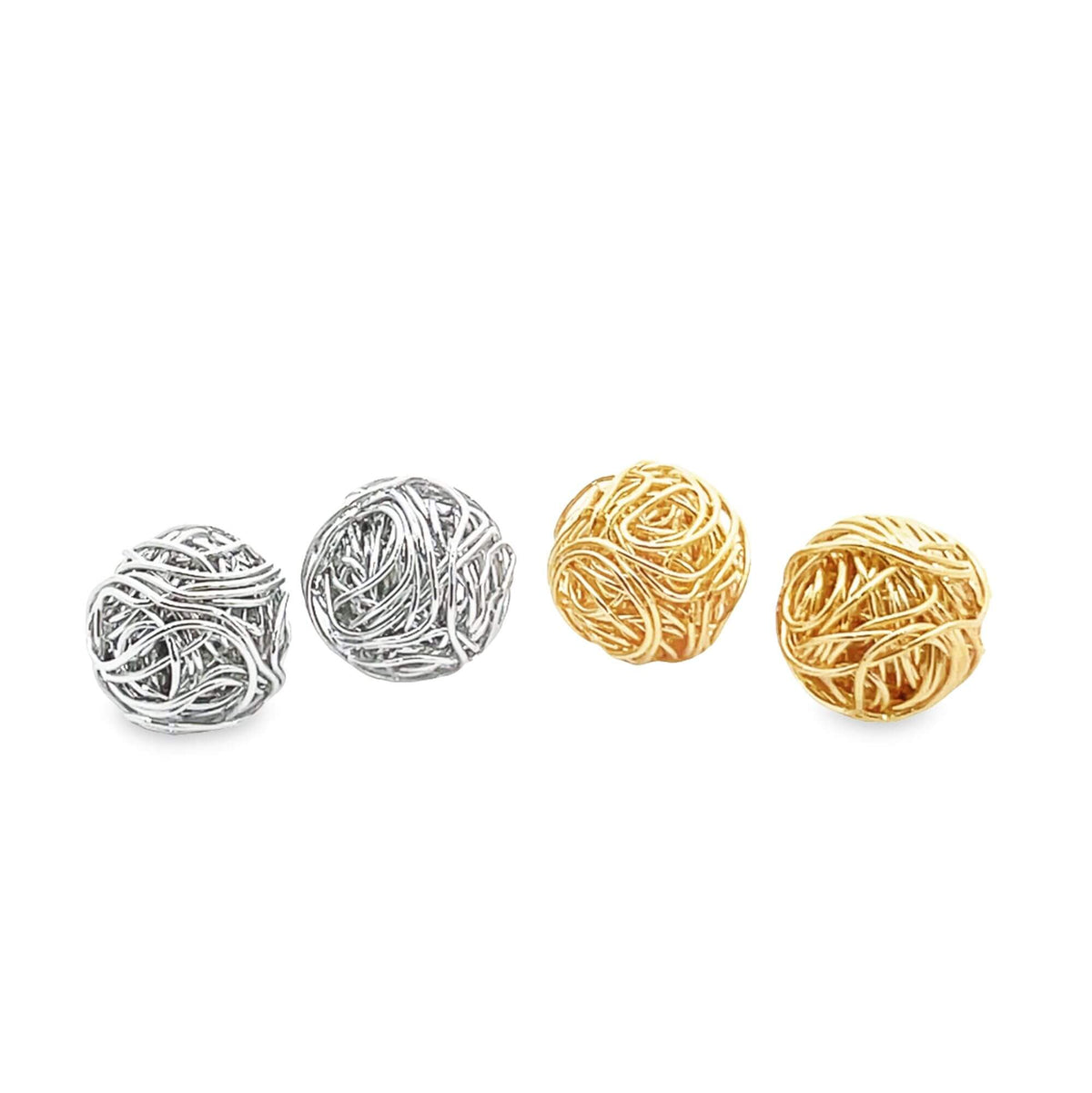 Two silver and two gold wire-wrapped ball beads rest on a white surface.