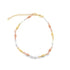 A delicate tri-color gold anklet features alternating yellow, white, and rose gold beads linked in a circle on a white background.