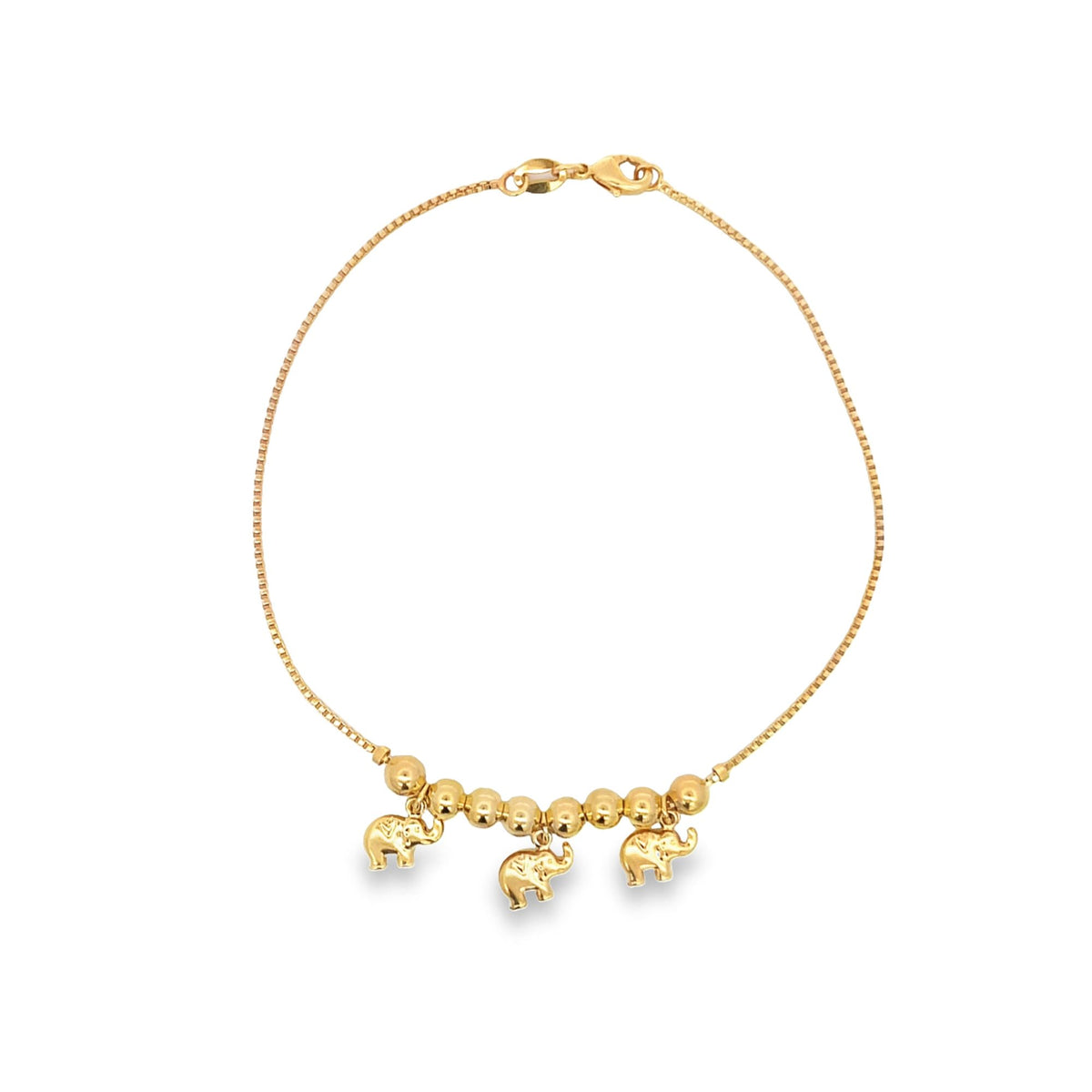 A delicate gold chain bracelet features three charming elephant charms dangling beneath a row of polished beads.