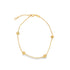 A delicate gold chain bracelet features four intricately ribbed, bead-like charms spaced evenly along its length against a clean white background.