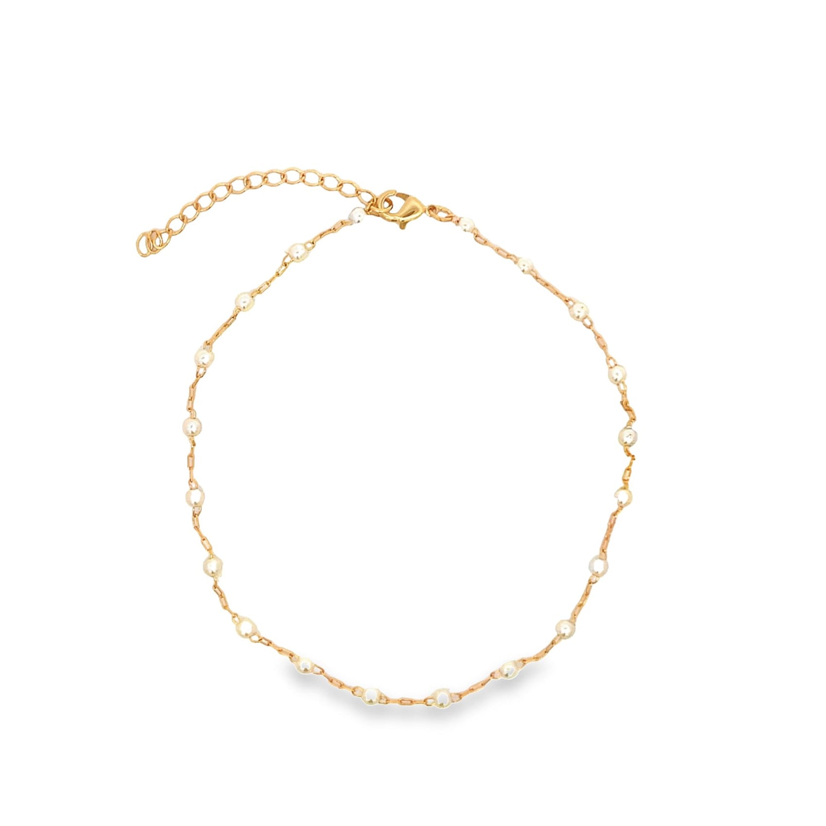 A delicate gold chain necklace sparkles with evenly spaced white beads against a clean white background.