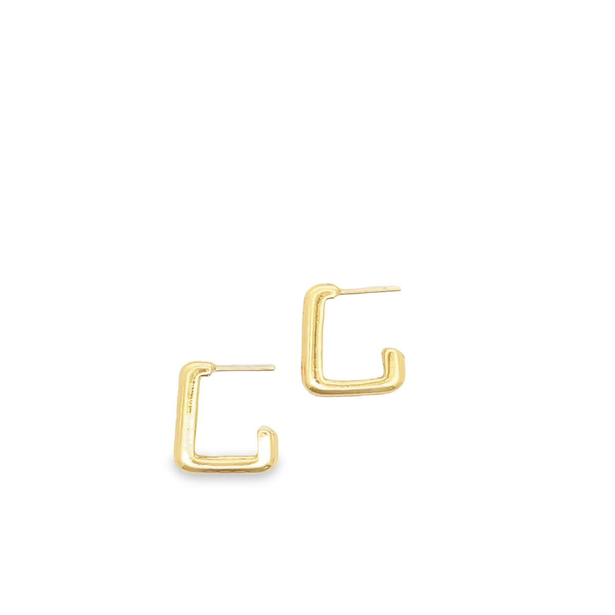 A pair of geometric gold huggie hoop earrings rests against a clean white background.