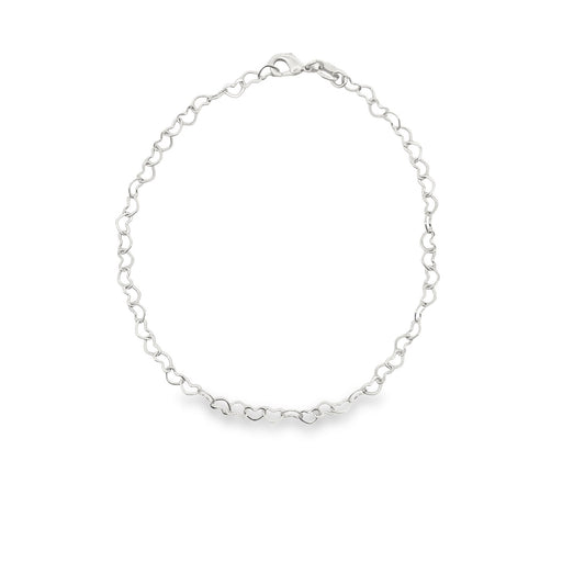 A delicate silver heart-link chain necklace rests in a circle on a clean white background.