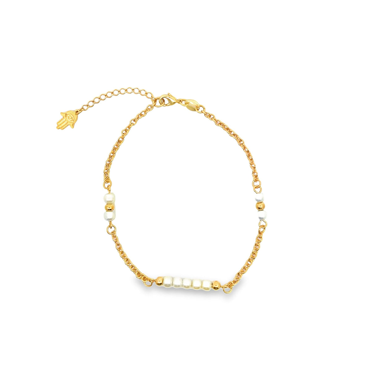 A delicate gold chain bracelet features alternating white pearls and a dangling Hamsa hand charm against a plain white background.
