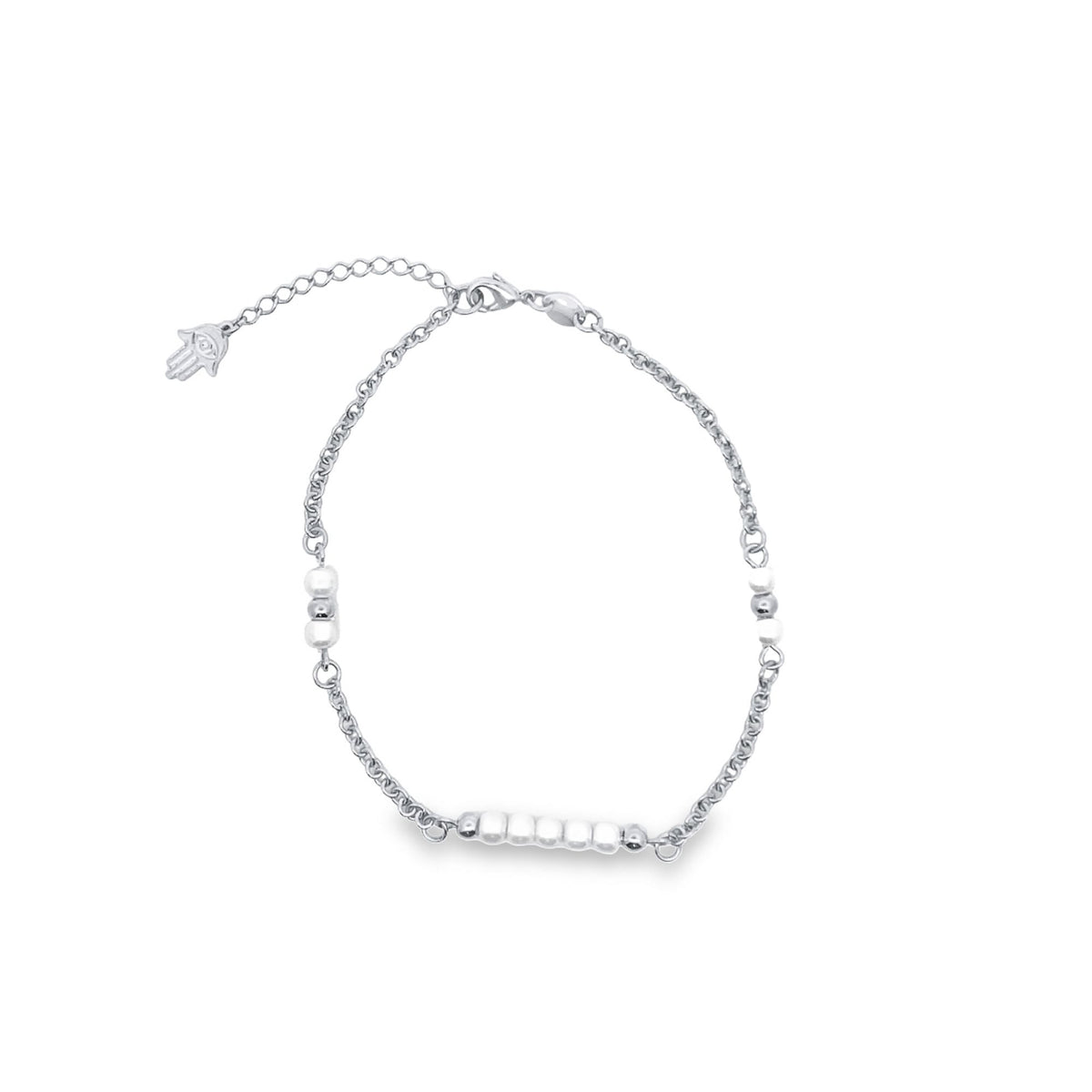 A delicate silver chain bracelet features a cluster of small white beads and a dangling Hamsa hand charm against a white background.