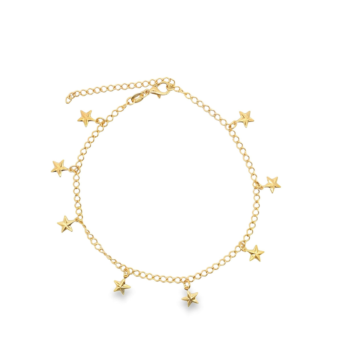 A delicate gold chain anklet dangles with several small star charms against a clean white background.