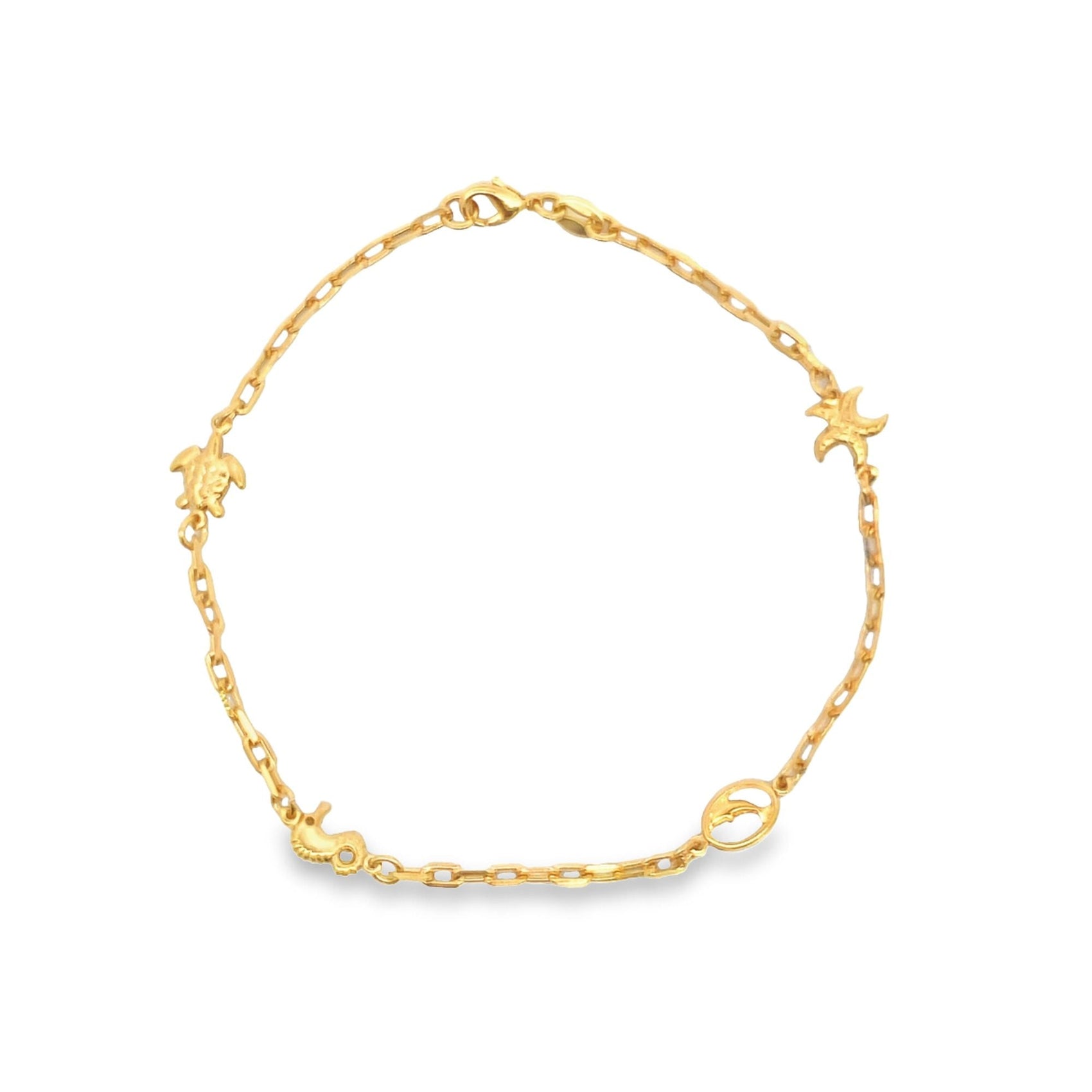 A delicate gold chain bracelet features charming marine charms, including a sea turtle, starfish, seahorse, and dolphin, displayed against a clean white background.