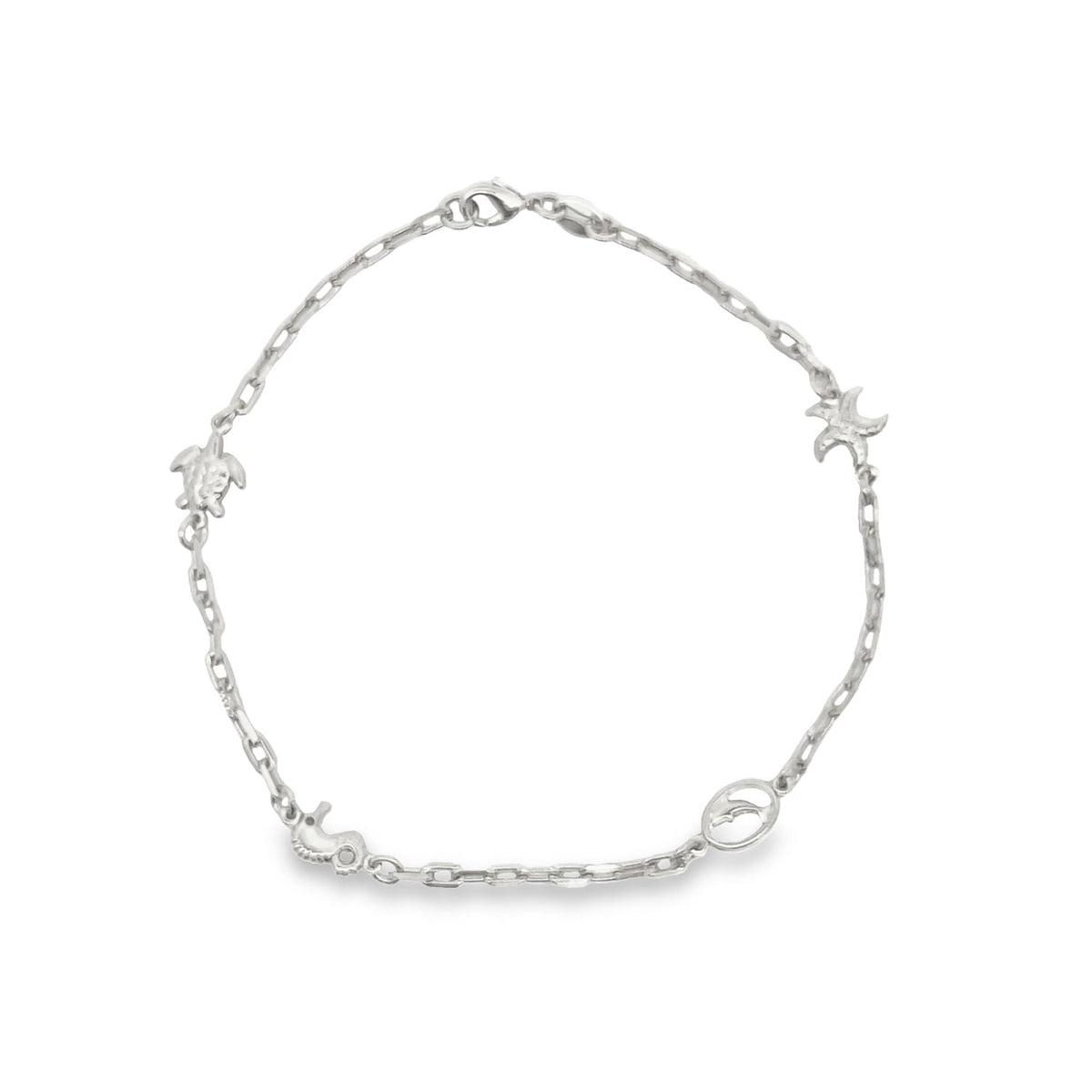 A delicate silver chain bracelet displays charming ocean-themed charms including a turtle, seahorse, and starfish.