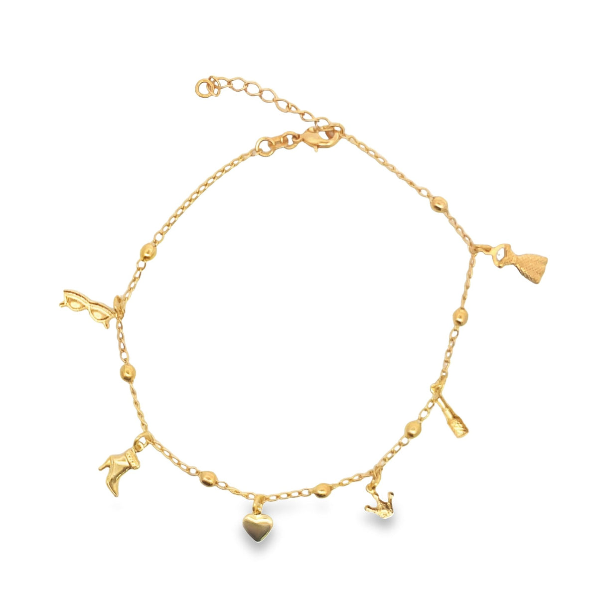 A gold charm anklet features playful dangling charms including a heart, boot, and sunglasses against a plain white background.