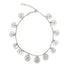 A delicate silver chain anklet features dangling coin charms in a curved arrangement against a white background.
