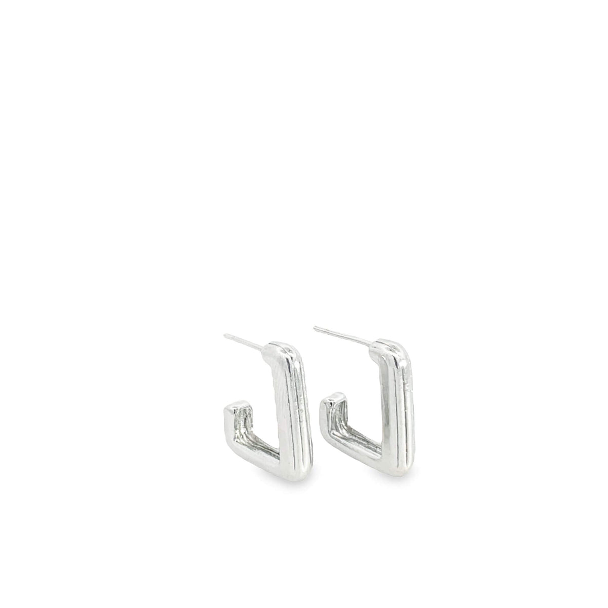 A pair of modern silver geometric square hoop earrings resting against a clean white background.
