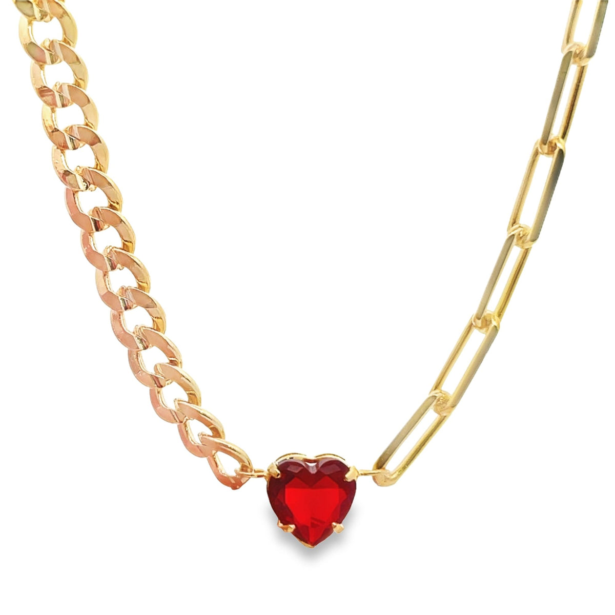 A gold-plated necklace features a vibrant red heart pendant suspended between a classic curb chain on the left and a modern paperclip chain on the right.