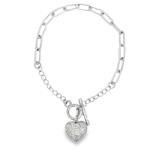 A silver toggle bracelet features a pave diamond heart charm hanging from a mixed paperclip and cable chain.