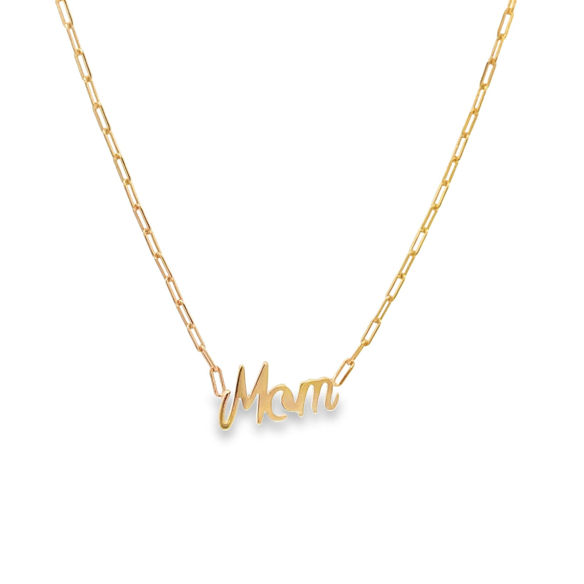 A delicate gold paperclip chain necklace displays a polished cursive "Mom" pendant centered against a clean white background.