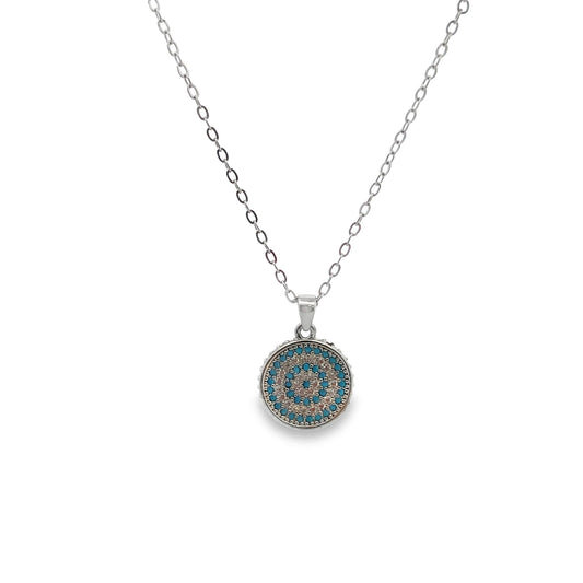 A delicate silver chain hangs with a round evil eye pendant featuring concentric circles of turquoise and white cubic zirconia stones.