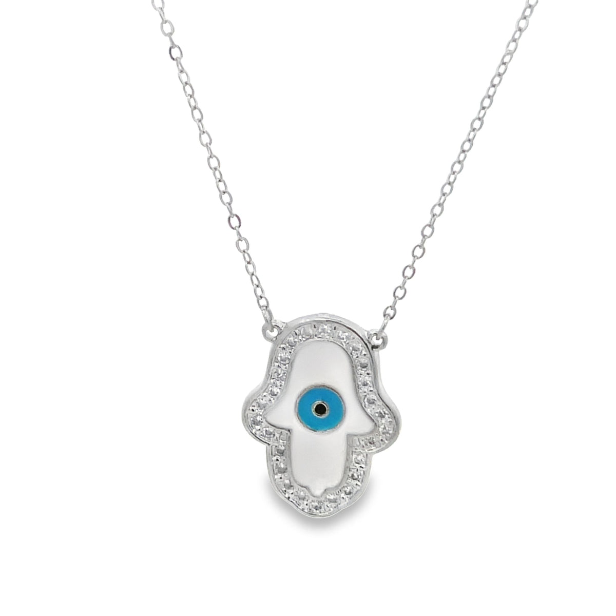A delicate silver chain necklace features a sparkling hamsa pendant accented with white enamel and a blue evil eye symbol in the center.