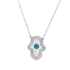 A silver Hamsa hand necklace features a white enamel center and a protective blue evil eye amulet accented with sparkling cubic zirconia crystals.