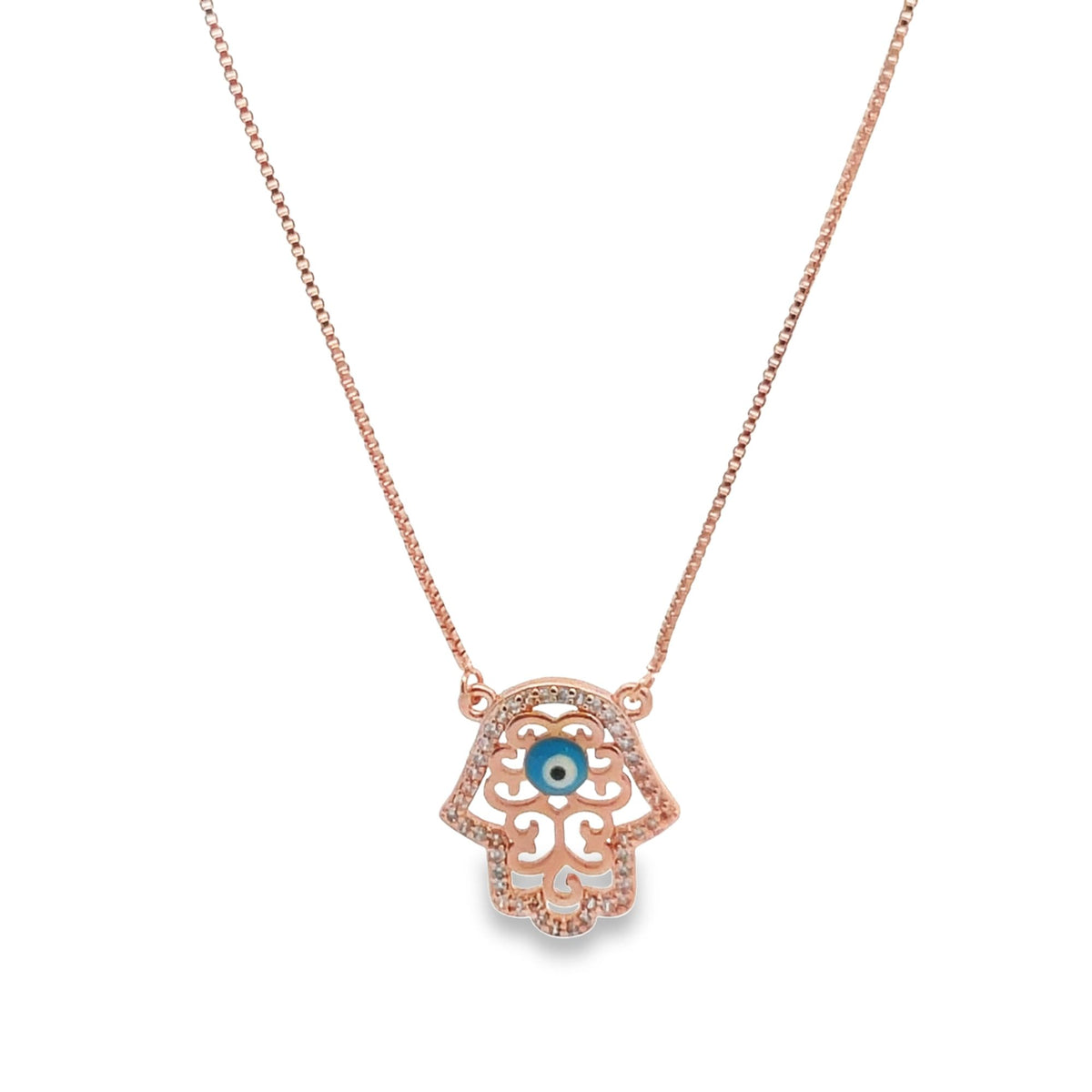 A delicate rose gold Hamsa hand necklace features a protective blue evil eye charm and sparkling pave diamonds.