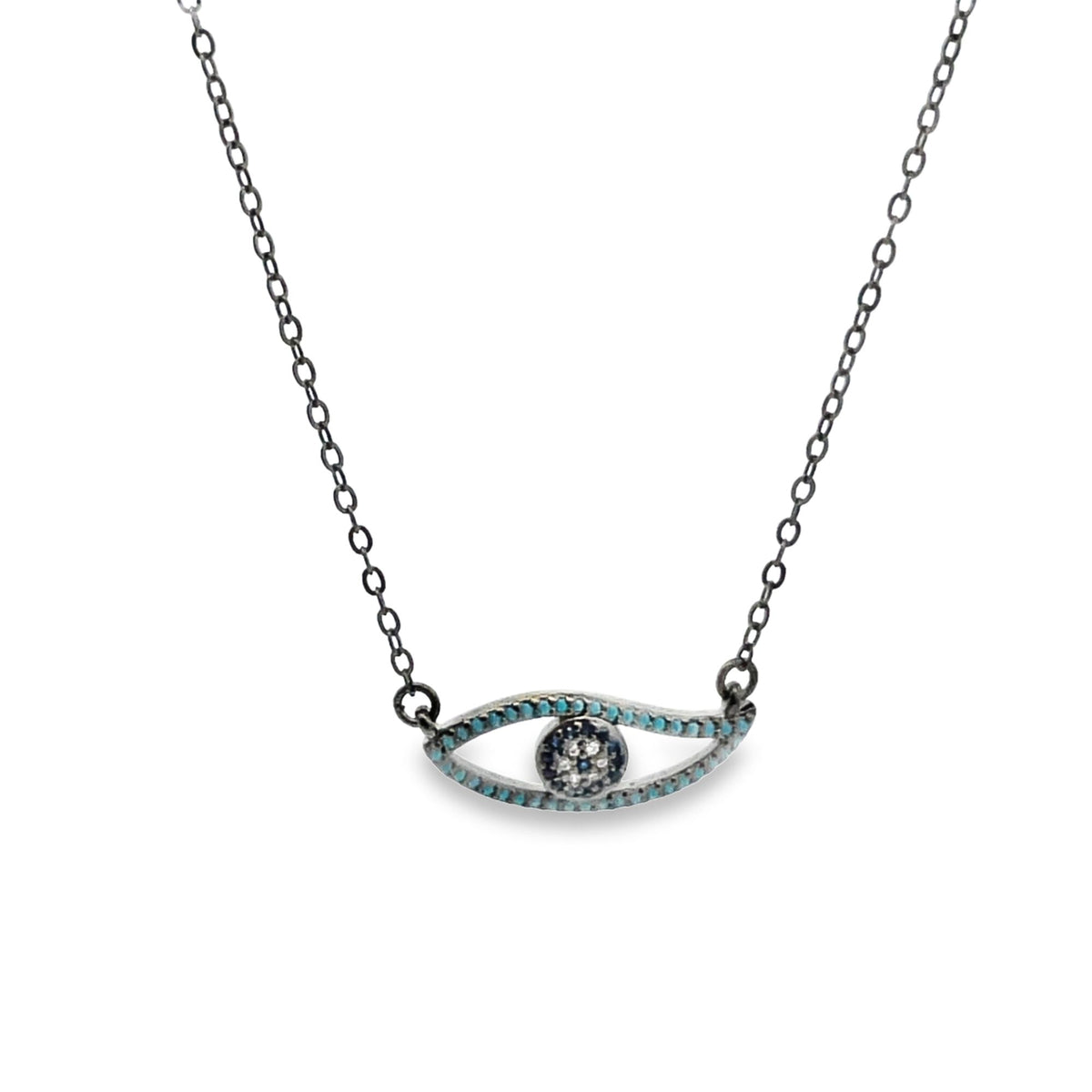 A delicate silver evil eye pendant necklace features a turquoise-accented eye motif hanging from a fine chain.