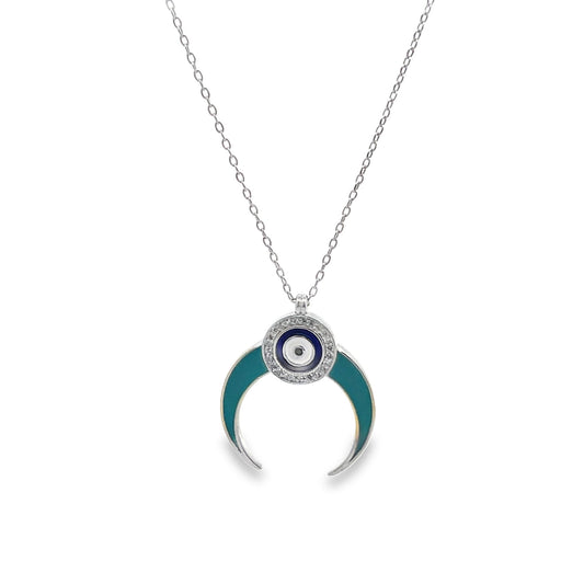 A silver chain necklace features a crescent-shaped pendant with teal enamel and an evil eye charm studded with tiny crystals.