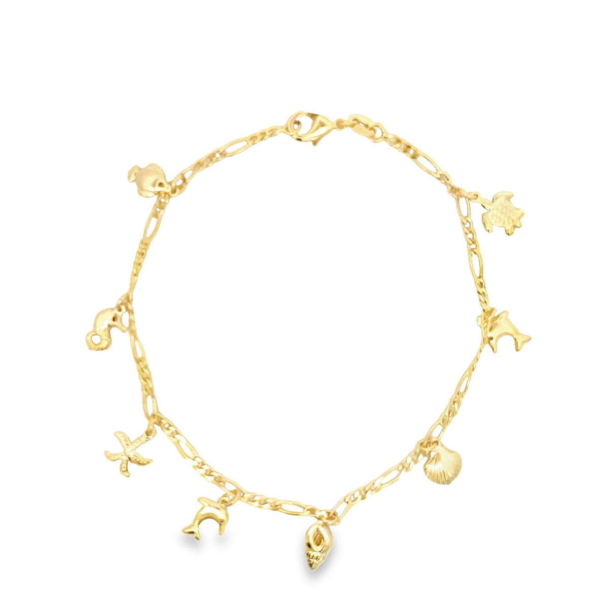 A delicate gold charm bracelet displays various ocean-themed pendants including a starfish, seahorse, and seashell.