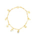 A delicate gold charm bracelet displays various ocean-themed pendants including a starfish, seahorse, and seashell.