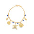A gold charm bracelet features dangling sea life charms, including a turtle and fish, accented with blue beads against a white background.