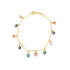 A delicate gold chain bracelet features colorful evil eye charms dangling along its length against a white background.