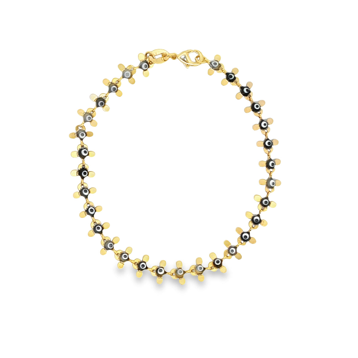 A gold flower necklace features black and white evil eye beads set into each petal and rests in a circular display.
