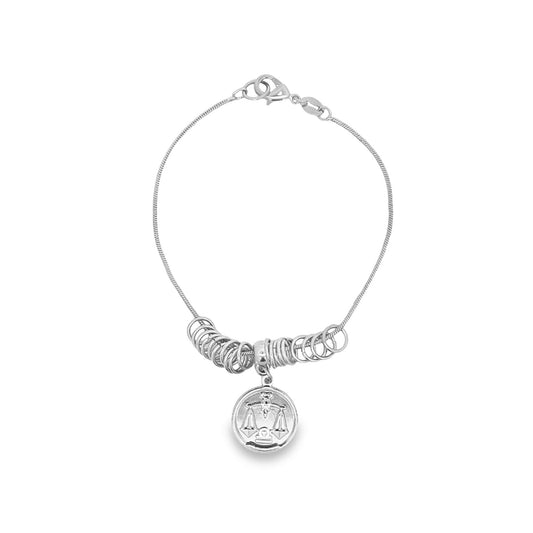 A silver Libra zodiac charm bracelet features multiple hanging rings along a delicate chain against a clean white background.